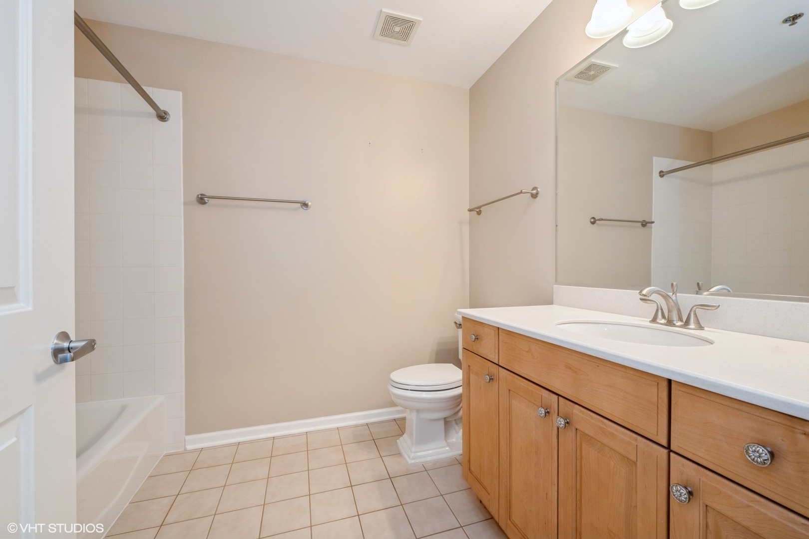 1199 East Port Clinton Road, Unit 610 Vernon Hills, IL 60061 - Photo 13 of 16 a bathroom with a granite countertop sink a toilet and a mirror