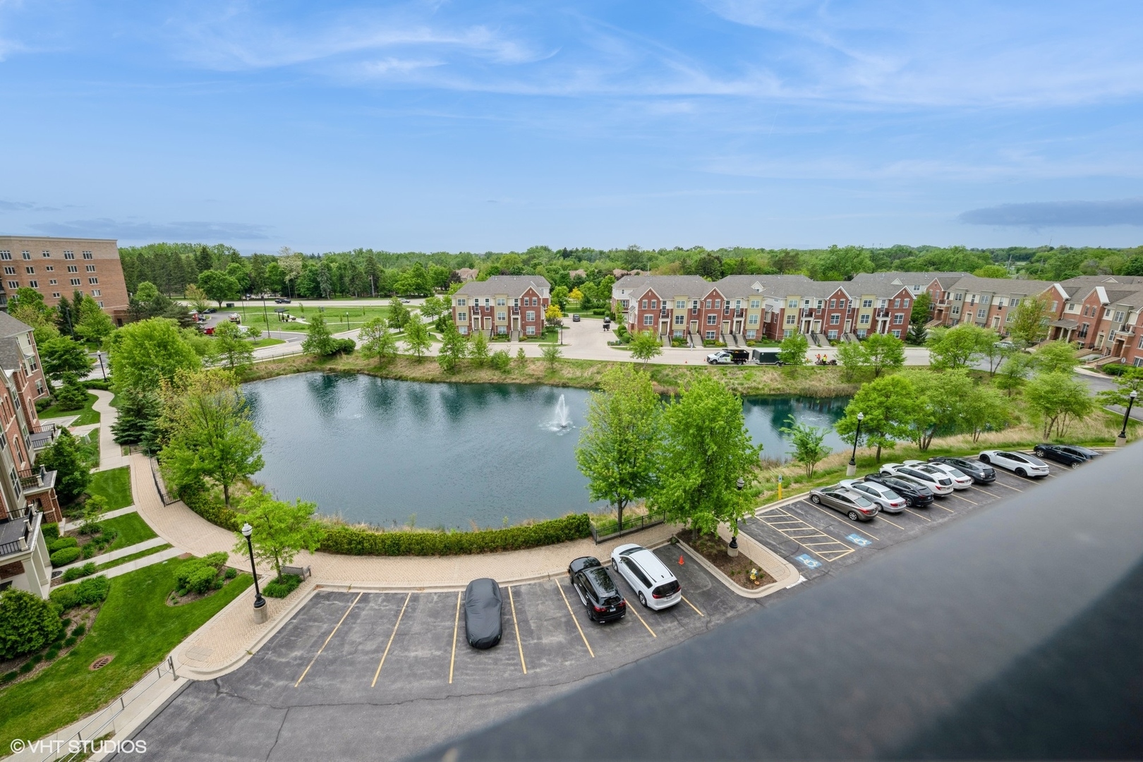 1199 East Port Clinton Road, Unit 610 Vernon Hills, IL 60061 - Photo 16 of 16 a view of a lake with lawn chairs and a big yard
