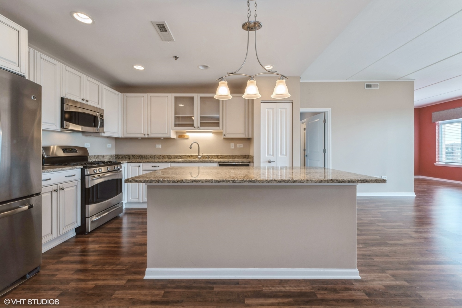 1199 East Port Clinton Road, Unit 610 Vernon Hills, IL 60061 - Photo 2 of 16 a kitchen with stainless steel appliances kitchen island granite countertop a stove a sink and a refrigerator