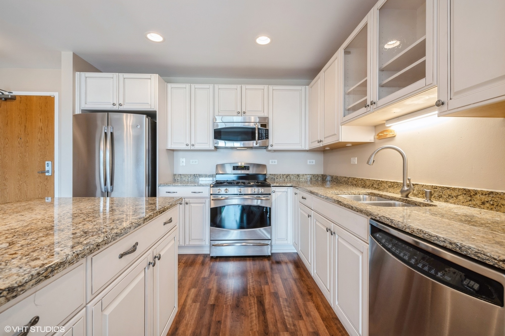 1199 East Port Clinton Road, Unit 610 Vernon Hills, IL 60061 - Photo 3 of 16 a kitchen with granite countertop a refrigerator stove top oven and sink