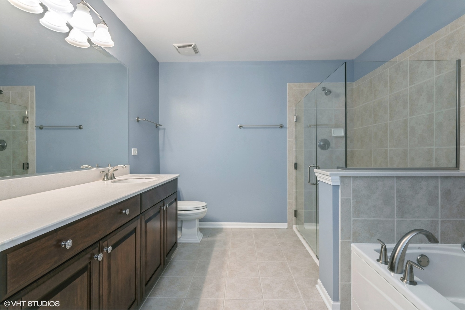 1199 East Port Clinton Road, Unit 610 Vernon Hills, IL 60061 - Photo 8 of 16 a bathroom with a double vanity sink and mirror