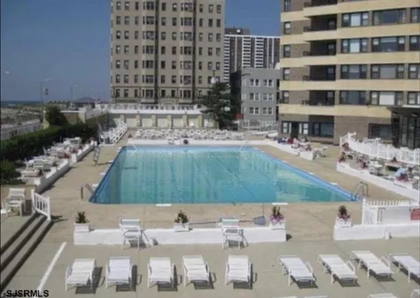 a view of swimming pool with outdoor seating