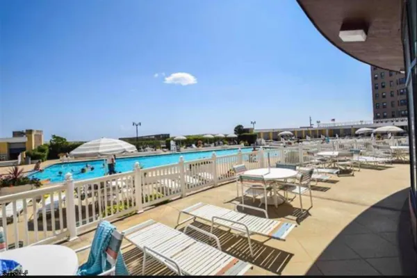 a view of a swimming pool with outdoor seating