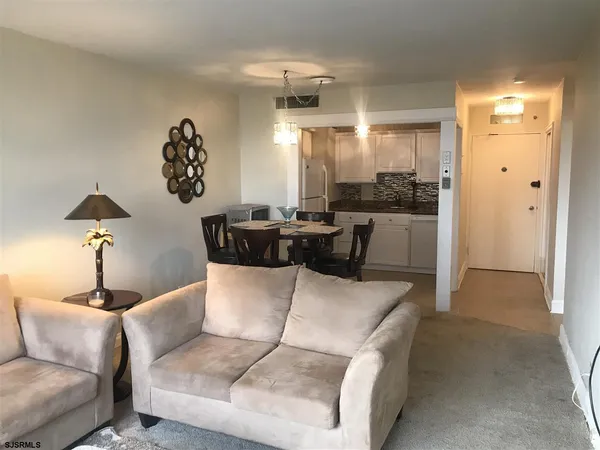 a living room with furniture and a chandelier