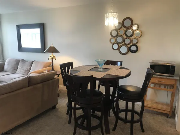 a view of a dining room with furniture and chandelier