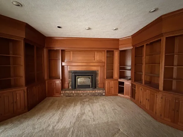 a view of an empty room with a fireplace