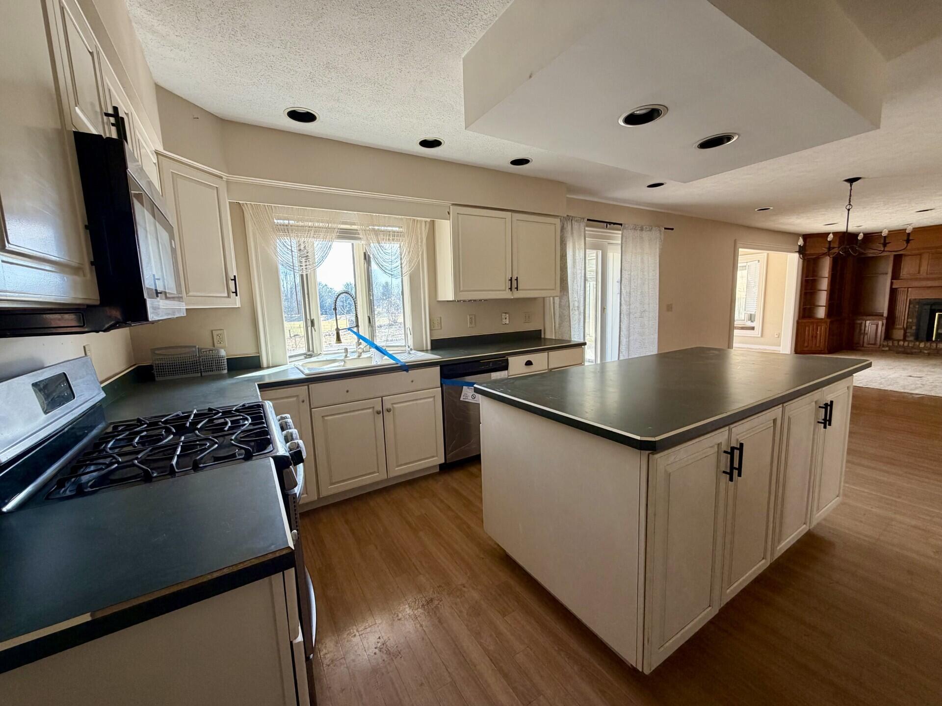 10859 Bunker Drive Demotte, IN 46310 - Photo 4 of 28 a kitchen with granite countertop a sink appliances cabinets and counter space