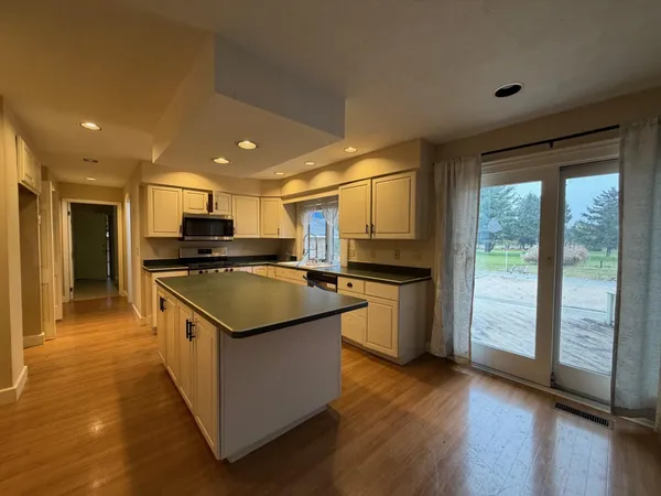 a kitchen with stainless steel appliances granite countertop a stove and a refrigerator
