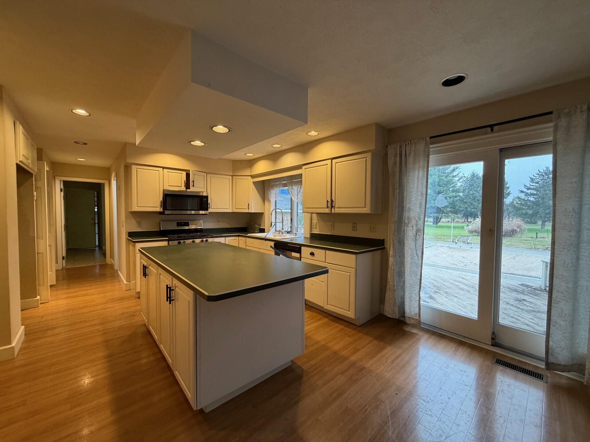 10859 Bunker Drive Demotte, IN 46310 - Photo 5 of 28 a kitchen with stainless steel appliances granite countertop a stove and a refrigerator