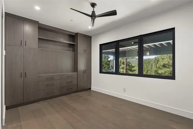 a dining room with furniture and a floor to ceiling window