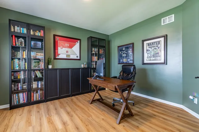a living room with furniture fireplace and a large window