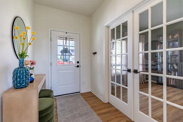 a view of a livingroom with wooden floor and stairs