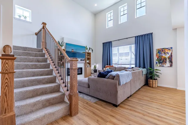 a living room with furniture fireplace and wooden floor