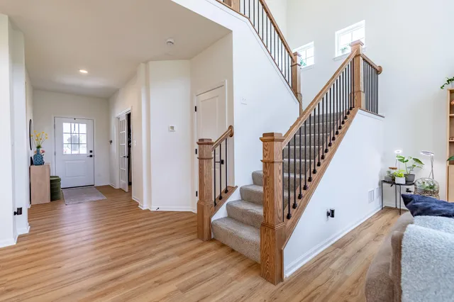 a kitchen with stainless steel appliances kitchen island granite countertop a table chairs and a refrigerator