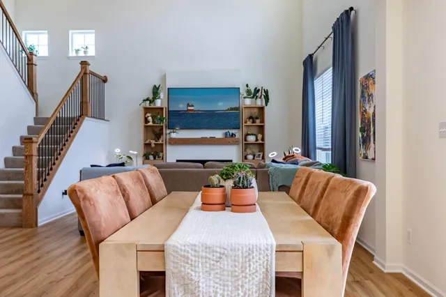 a view of a dining room with furniture and wooden floor