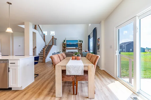 a kitchen with stainless steel appliances a sink a stove a microwave a refrigerator and cabinets