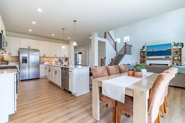 a kitchen with stainless steel appliances white cabinets and a refrigerator
