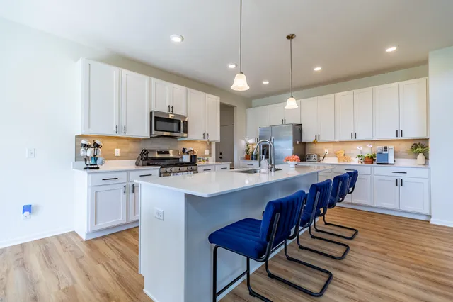 a dining room with furniture and wooden floor