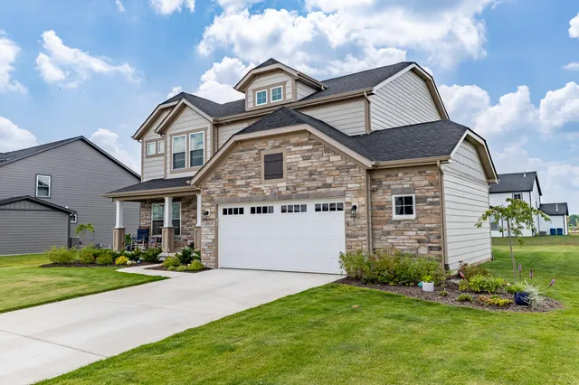 a front view of a house with a garden and plants