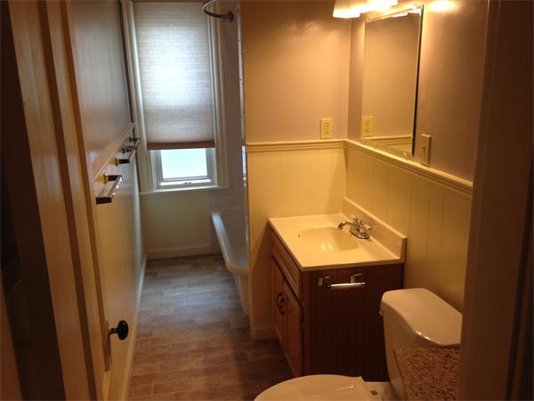 7 Ekman Street Worcester, MA 01607 - Photo 4 of 11 a bathroom with a sink a toilet a mirror and vanity