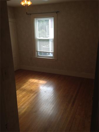 7 Ekman Street Worcester, MA 01607 - Photo 8 of 11 wooden floor in an empty room with a window