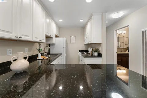 a kitchen with sink and cabinets