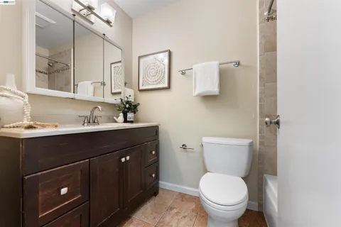 a bathroom with a sink vanity mirror and toilet