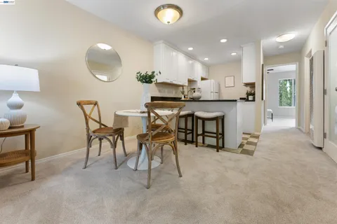a view of kitchen with furniture and a refrigerator