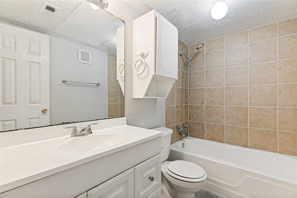 5522 Boca Raton Boulevard, Unit 404 Fort Worth, TX 76112 - Photo 12 of 12 Bathroom featuring a white vanity with integrated sink, chrome faucet, and a large wall mirror