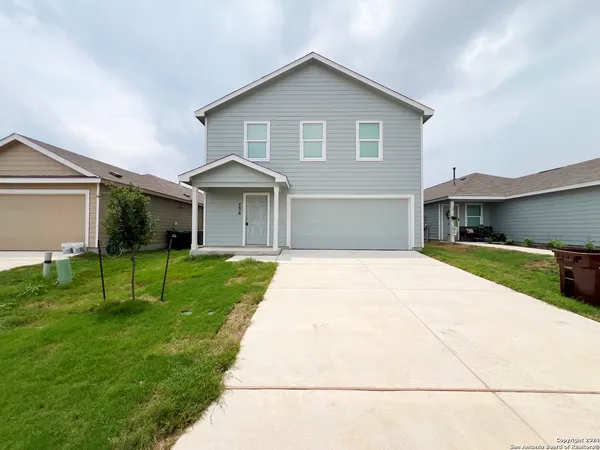 a front view of house with a garden and patio