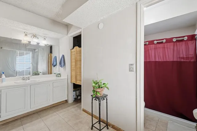a spacious bathroom with a double vanity sink and a mirror