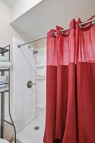 a bathroom with a shower curtain and a window