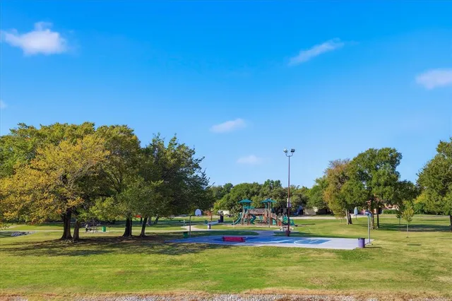 a view of a park with large trees