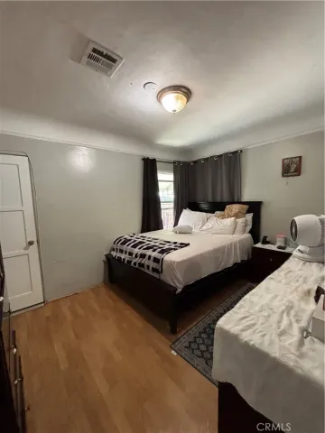 a bedroom with two beds and a large mirror