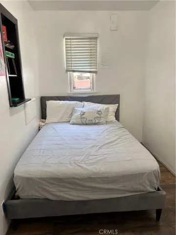 a bedroom with a bed and flat screen tv