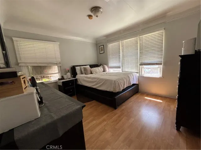 a bedroom with double bed and a flat tv screen on dresser