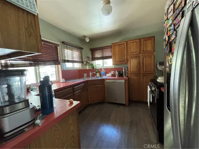 a kitchen with stainless steel appliances a refrigerator and a sink