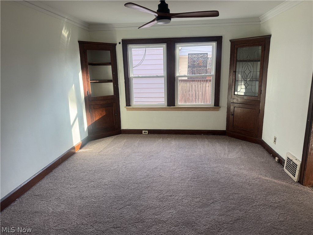 4058 Ardmore Road Cleveland, OH 44121 - Photo 5 of 14 Unfurnished room with ornamental molding, carpet flooring, and a ceiling fan