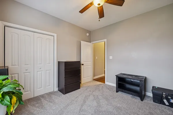 a living room with furniture and a ceiling fan