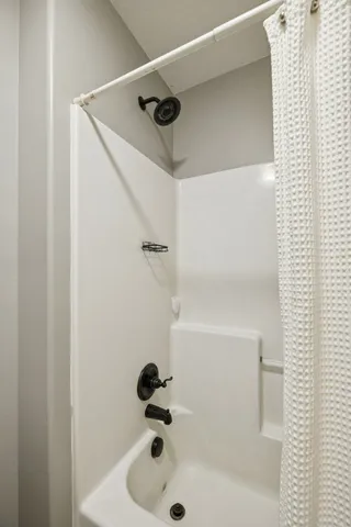 a bedroom with furniture and a flat screen tv