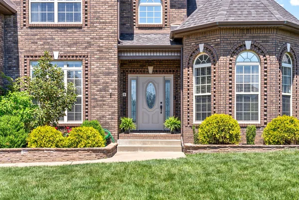 a front view of a house with garden