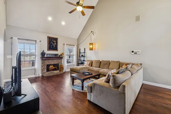 a living room with furniture and a fireplace