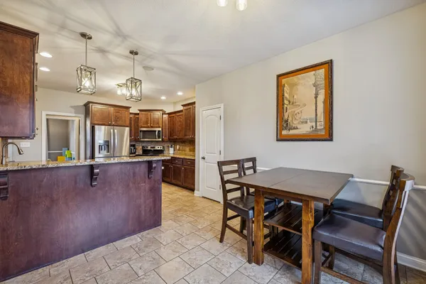 a view of a dining room with furniture and a kitchen