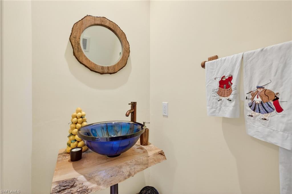 4030 Crayton Road, Unit C2 Naples, FL 34103 - Photo 20 of 32 a bathroom with a sink and a mirror