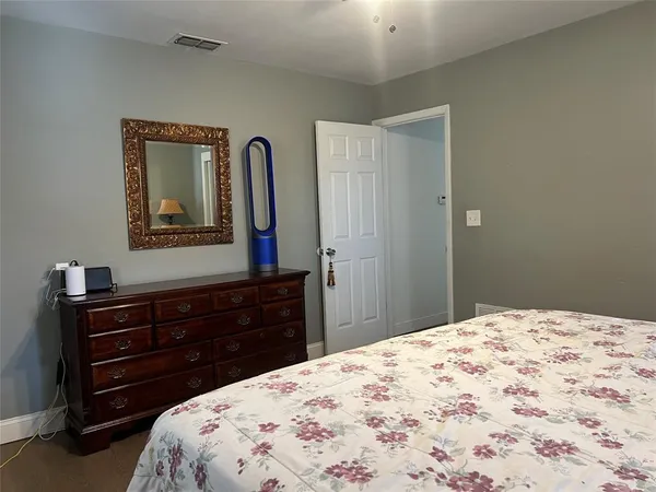 a bedroom with a bed and a dresser