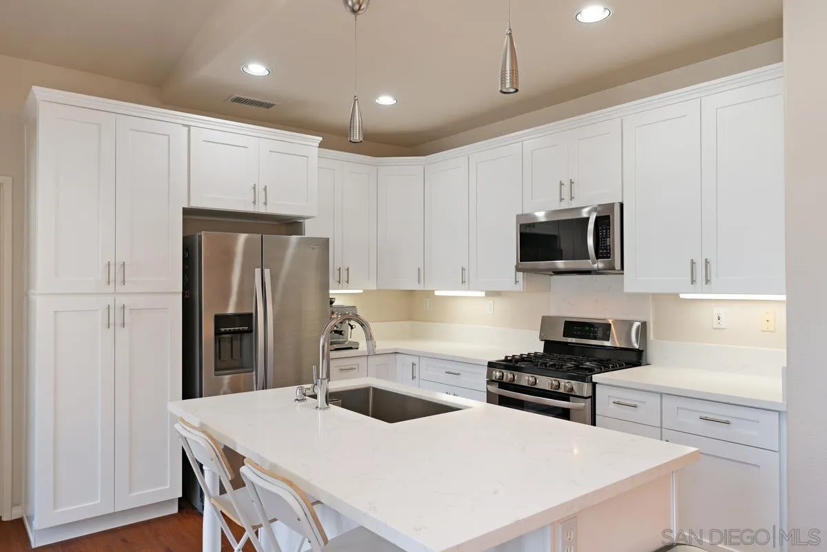 11456 Miro Circle San Diego, CA 92131 - Photo 14 of 34 a kitchen with stainless steel appliances a refrigerator stove microwave and cabinets