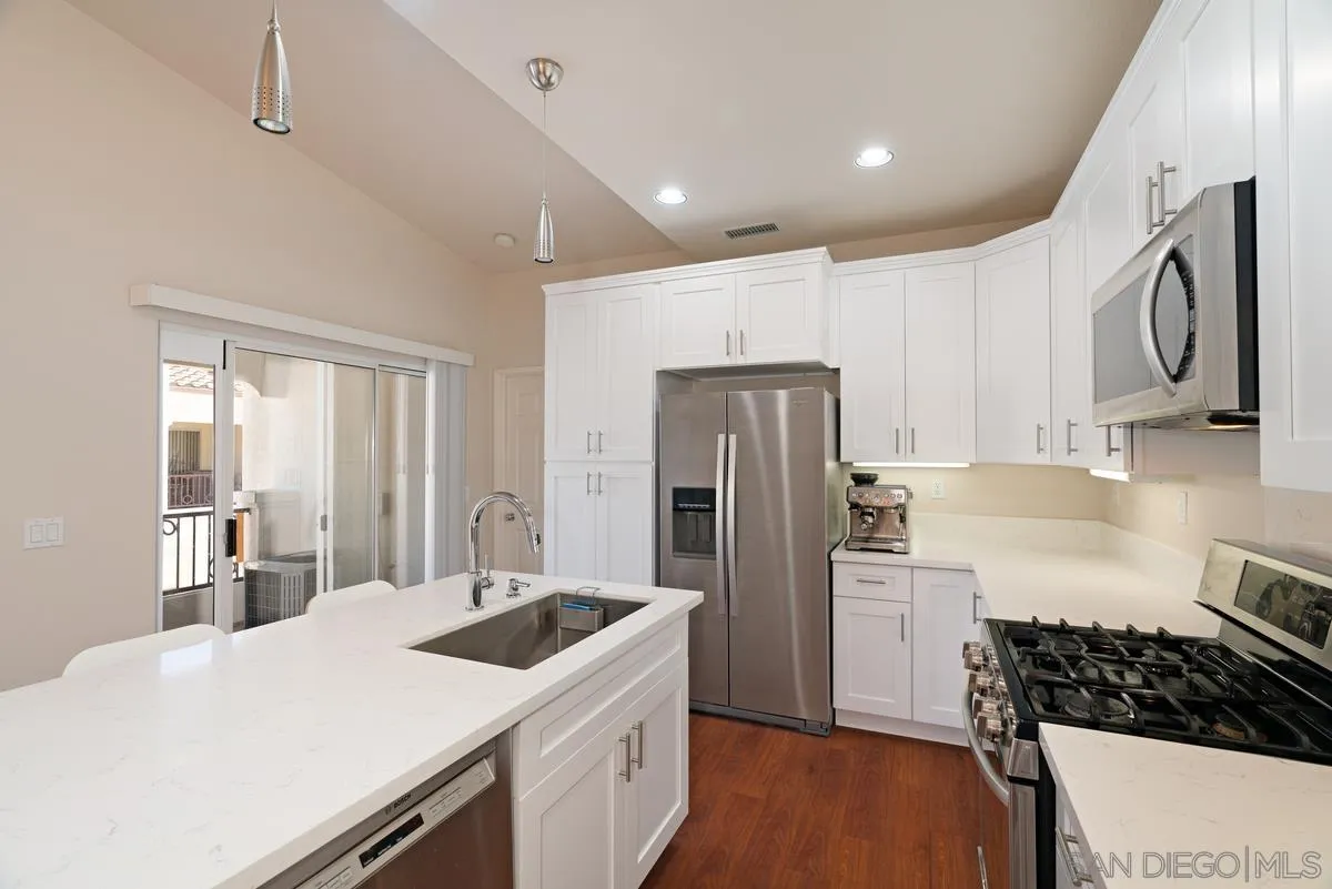11456 Miro Circle San Diego, CA 92131 - Photo 15 of 34 a kitchen with refrigerator cabinets and stove