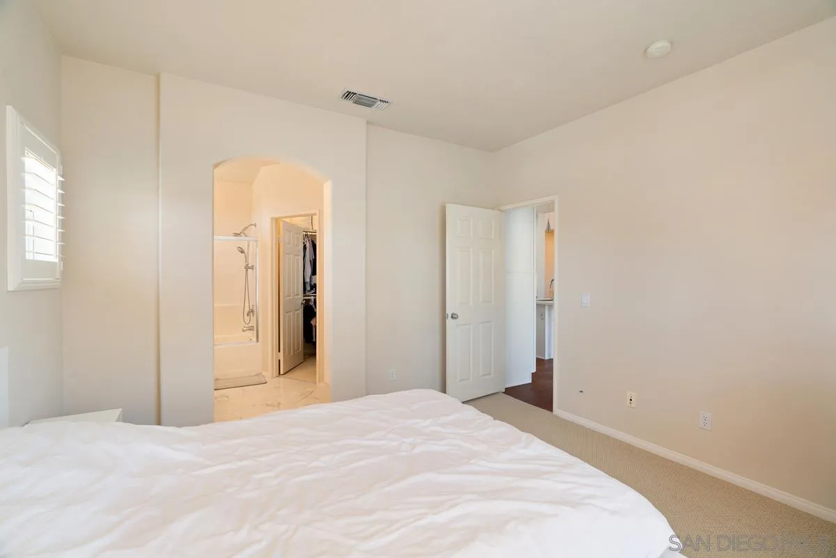11456 Miro Circle San Diego, CA 92131 - Photo 21 of 34 a bedroom with a bed and cabinets