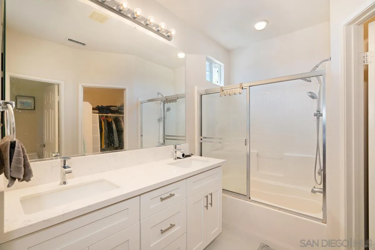 11456 Miro Circle San Diego, CA 92131 - Photo 22 of 34 a bathroom with double vanity sink and a mirror