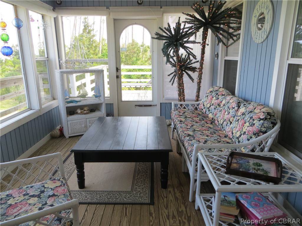 2818 Haven Beach Road Diggs, VA 23045 - Photo 11 of 17 Sunroom across front with acces to east side of deck for private sunning and entertaining.